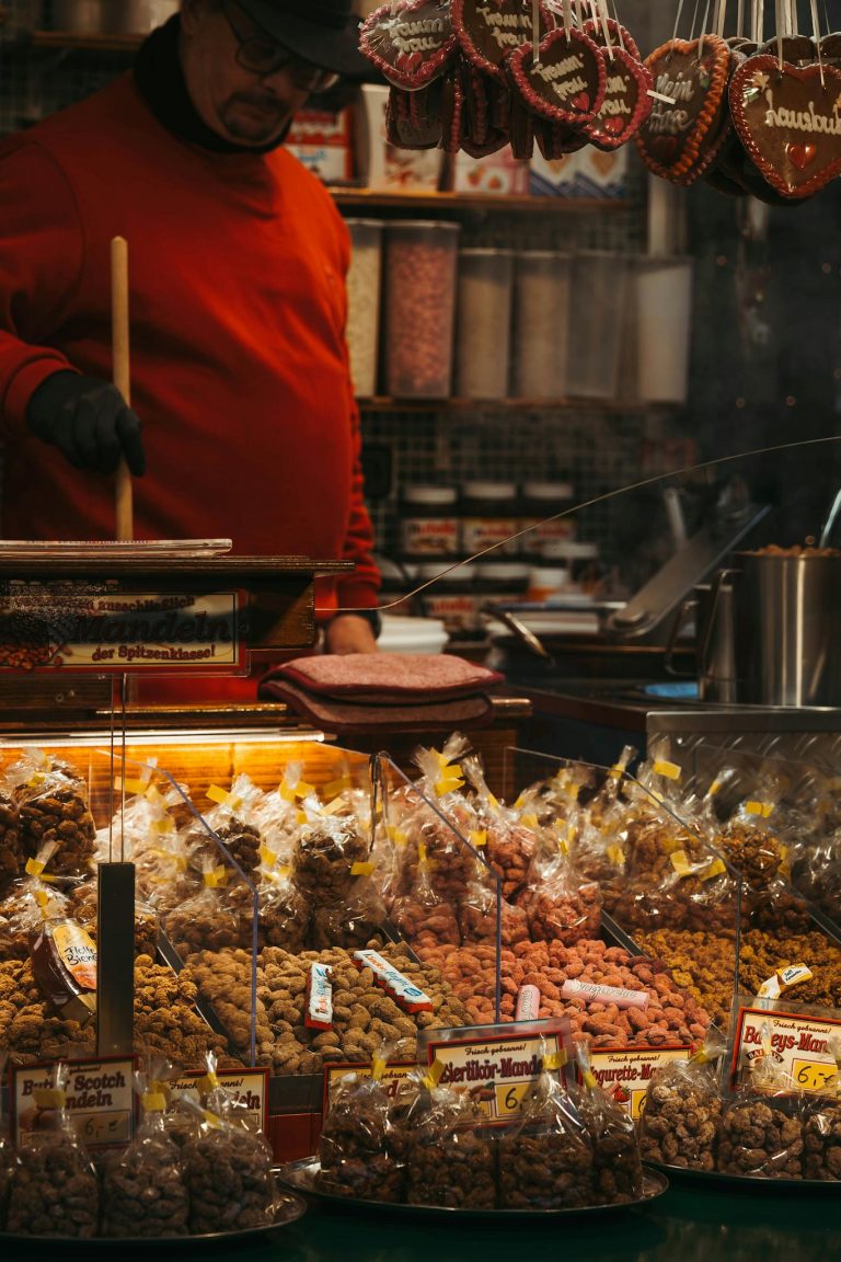 A vendor at a Christmas market sells assorted candies and treats in Berlin.
