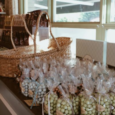 Charming artisanal candy shop display with rustic baskets and sunlight streaming in through large windows.
