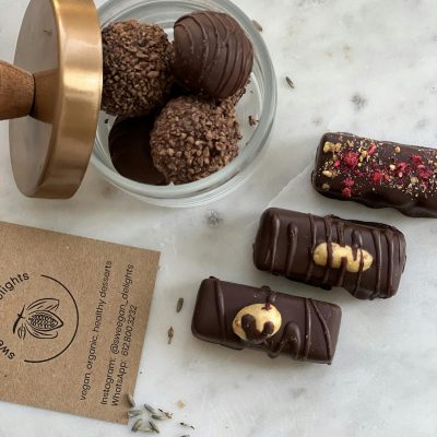 Elegant display of assorted chocolate truffles and bars with natural decor.